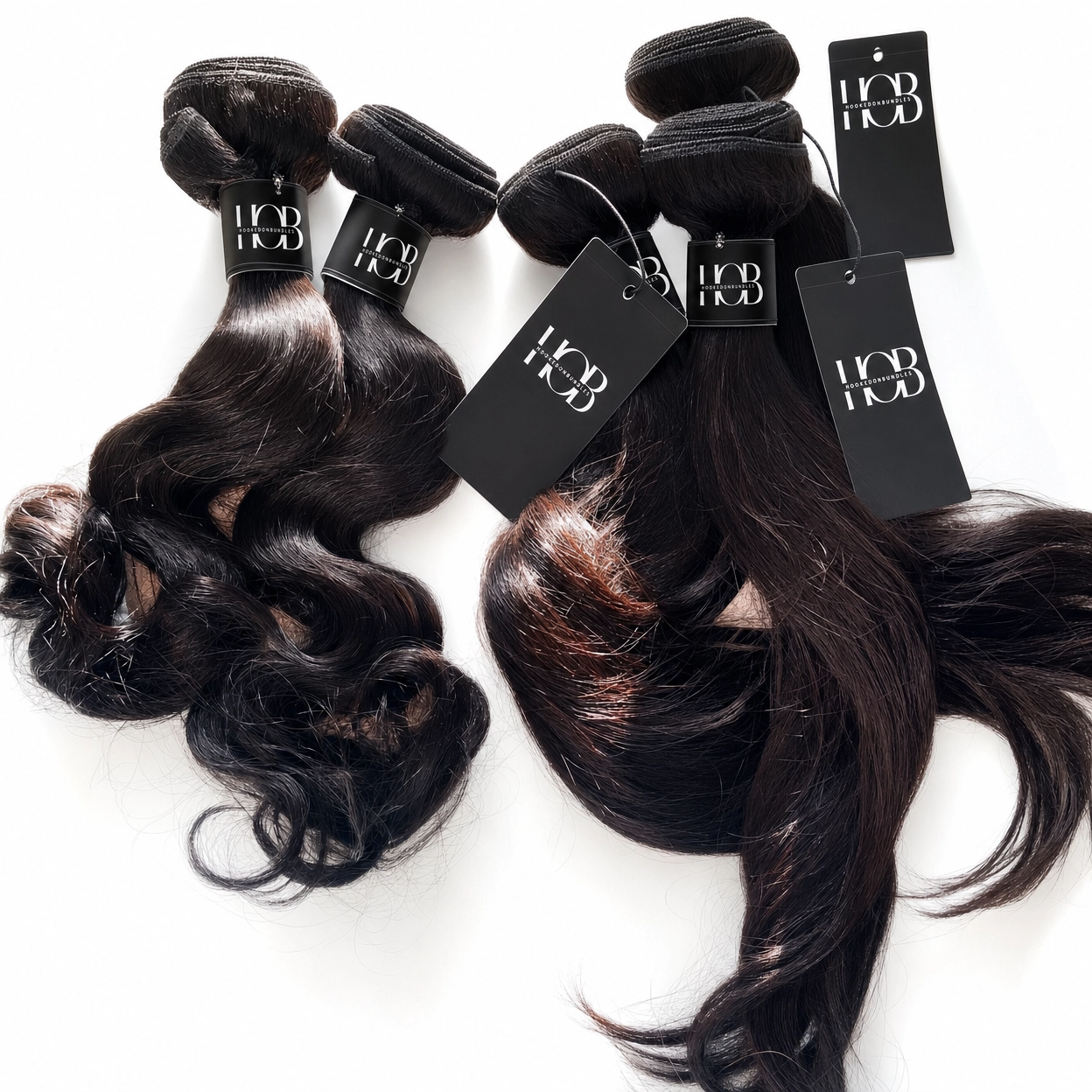 Three bundles of wavy hair extensions with 'HOD' branding on a white background. HookedOnBundles Virgin Hair