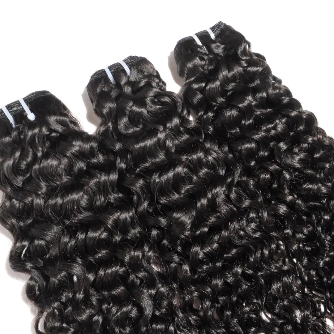 Three bundles of deep wave hair extensions against a white background. HookedOnBundles Virgin Hair