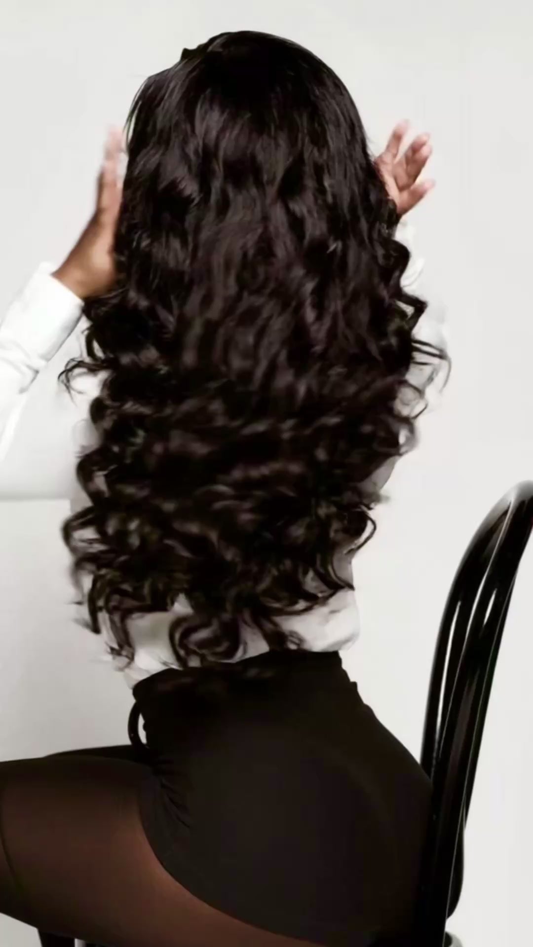 women in white shirt and black skirt with long wavy hair
 HookedOnBundles Virgin Hair